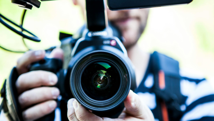 Close-up of a man holding a camera