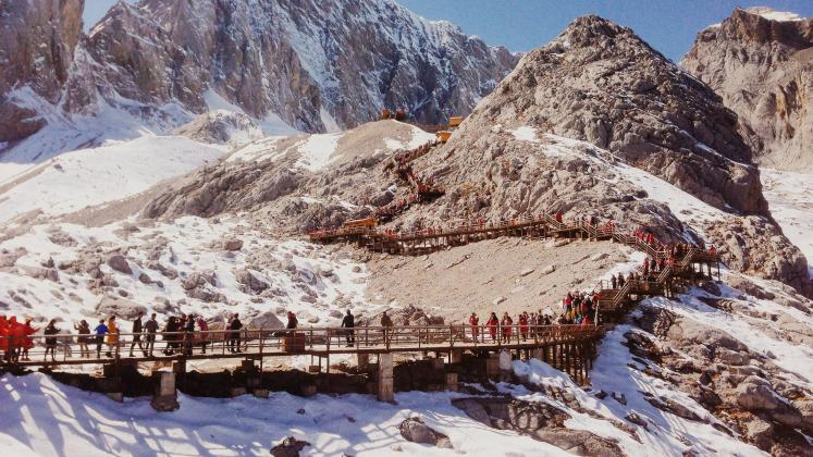 People Climbing Mountains in Lijiang, China 