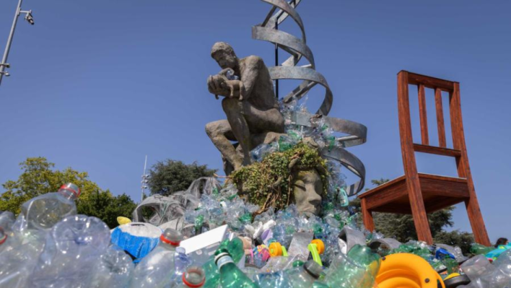 Discarded plastic is placed in front of a statue in Geneva, Switzerland. 