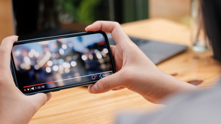 A YouTube video plays on a smartphone