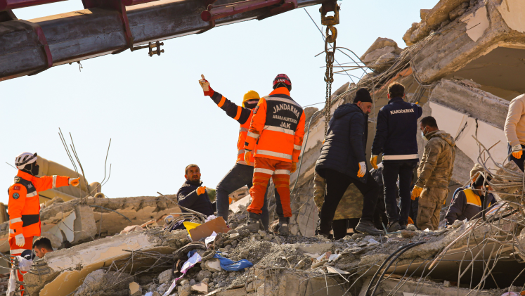 Rescue workers among the rubble after an earthquake