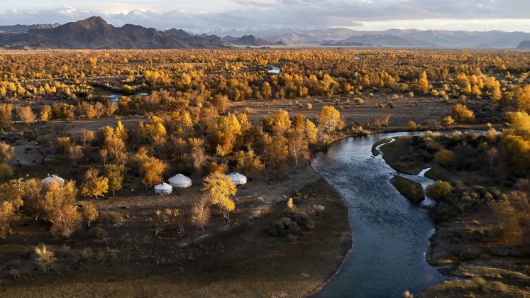 mongolian landscape with yurts and river