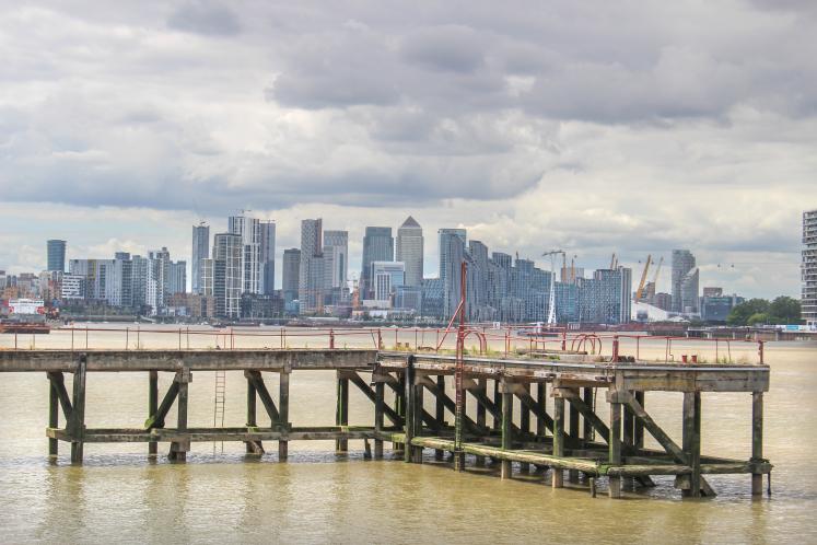London / UK - July 10 2020: View of a jetty pier and downtown London from the River Thames, UK