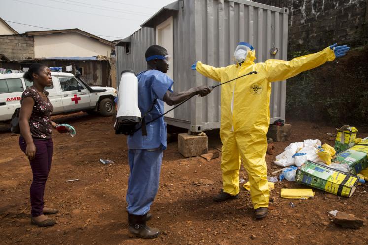 A person is disinfected during an Ebola outbreak in Freetown, Sierra Leone. 