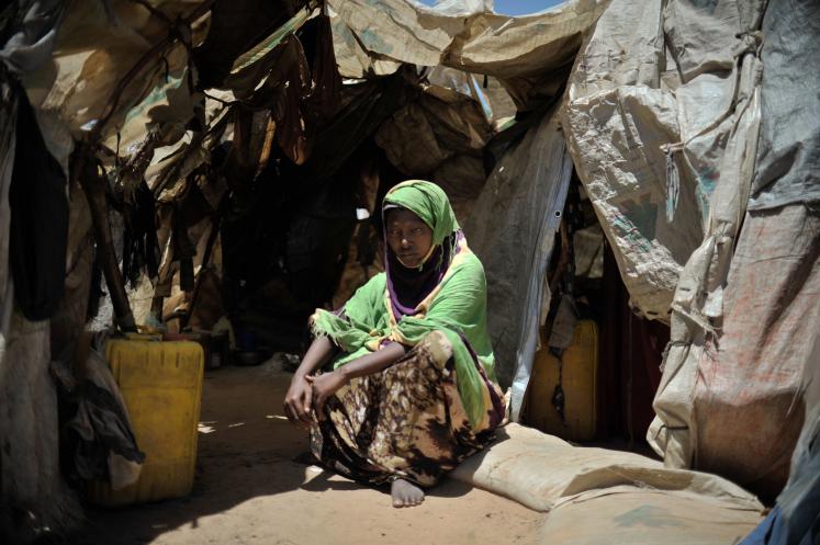 A woman sits outside her home in Mogadishu, Somalia.