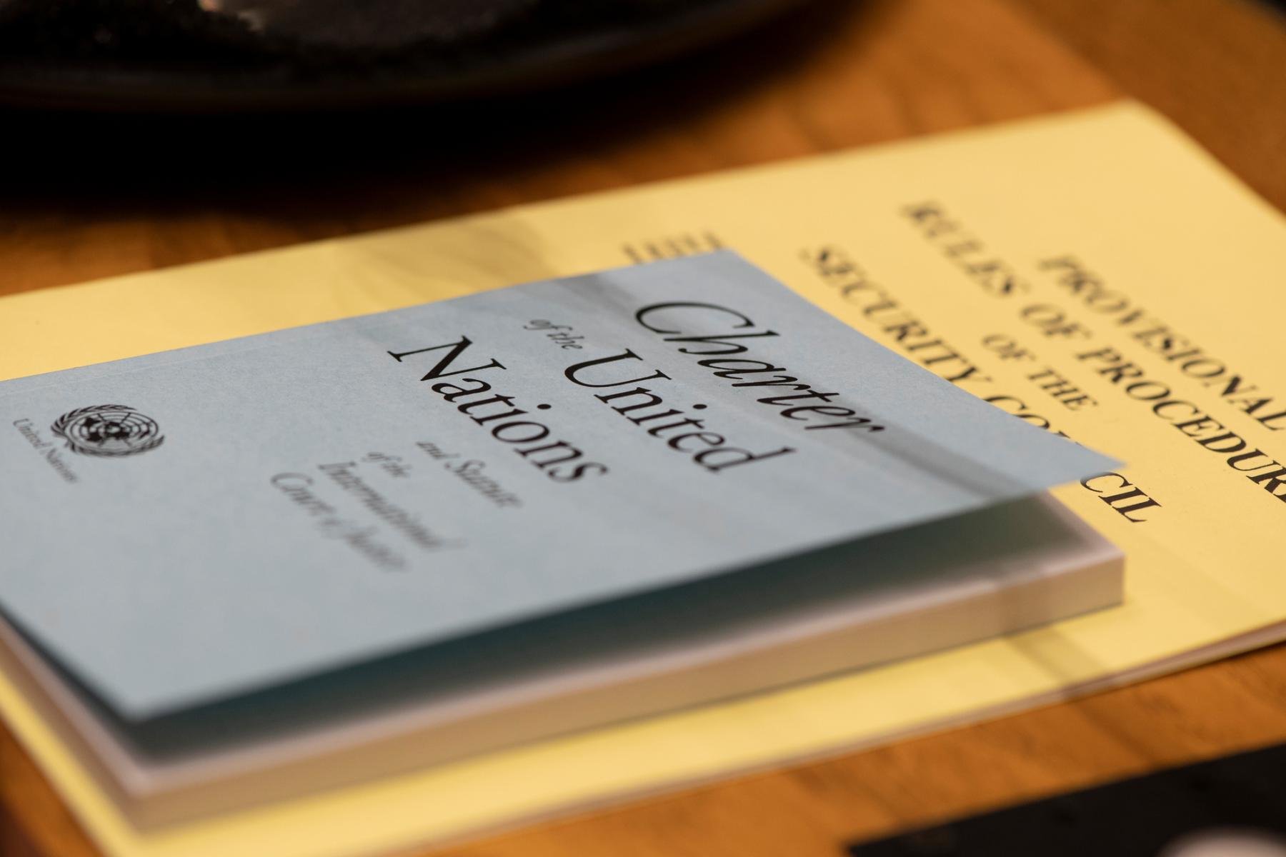 A detail of the United Nations Charter and the Provisional Rules of Procedure of the Security Council, photographer on the table in the Council chamber.