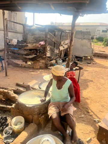 Farmer processing gari(grated, roasted cassava)