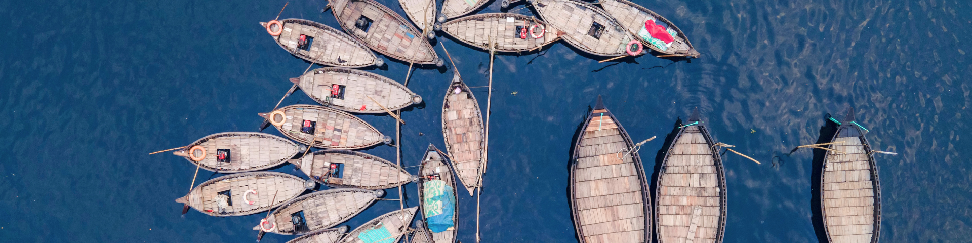 Aerial view of a group of boats clustered together in the ocean