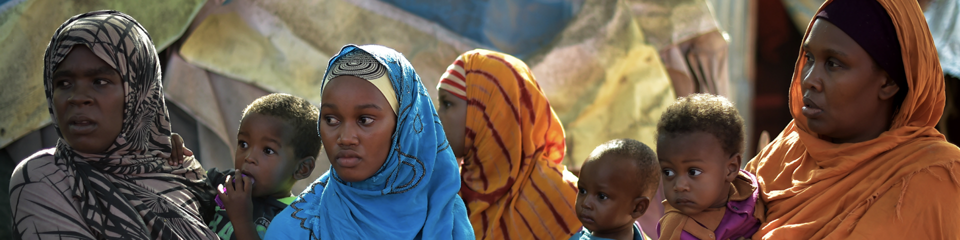 A group of Somali women stand near a water point at the Dayniile IDP camp.