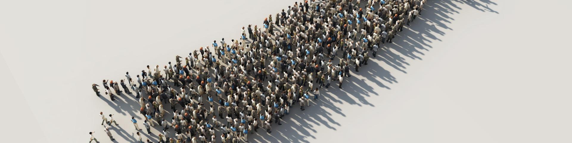 Stock aerial photo of a group of people forming a shape of an arrow