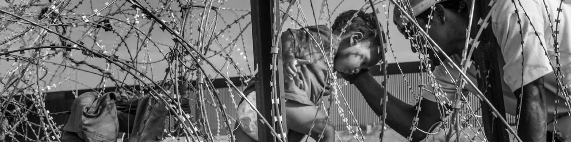 child are border through razor wire